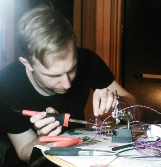 Kyle soldering cables before the show